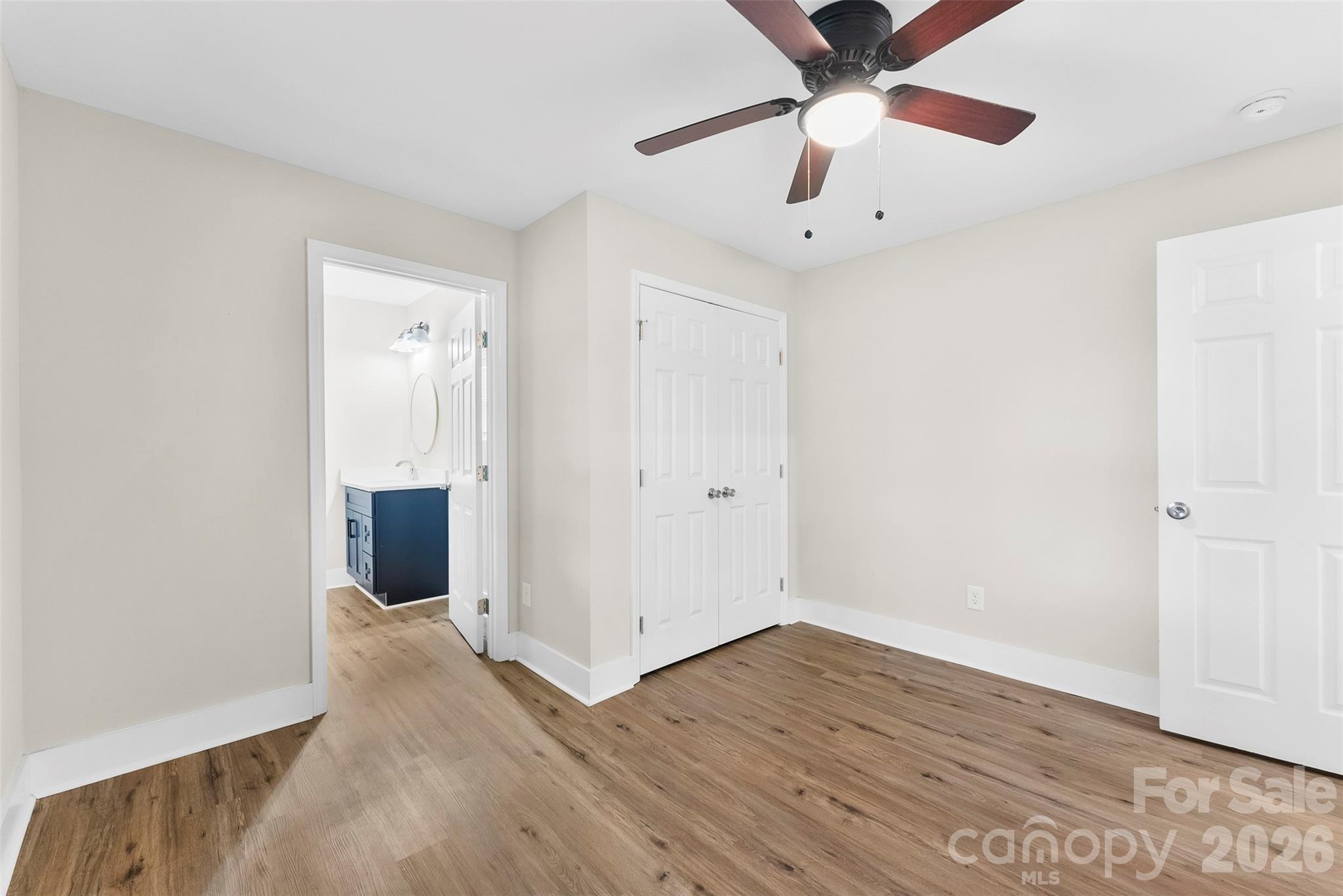 601 Rhyne Circle, Unit B Gastonia, NC 28054 - Photo 14 of 32 an empty room with wooden floor a ceiling fan and closet