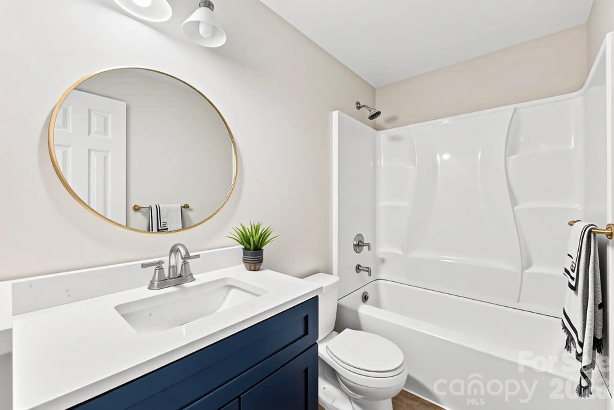 601 Rhyne Circle, Unit B Gastonia, NC 28054 - Photo 20 of 32 a bathroom with a sink a toilet and a mirror