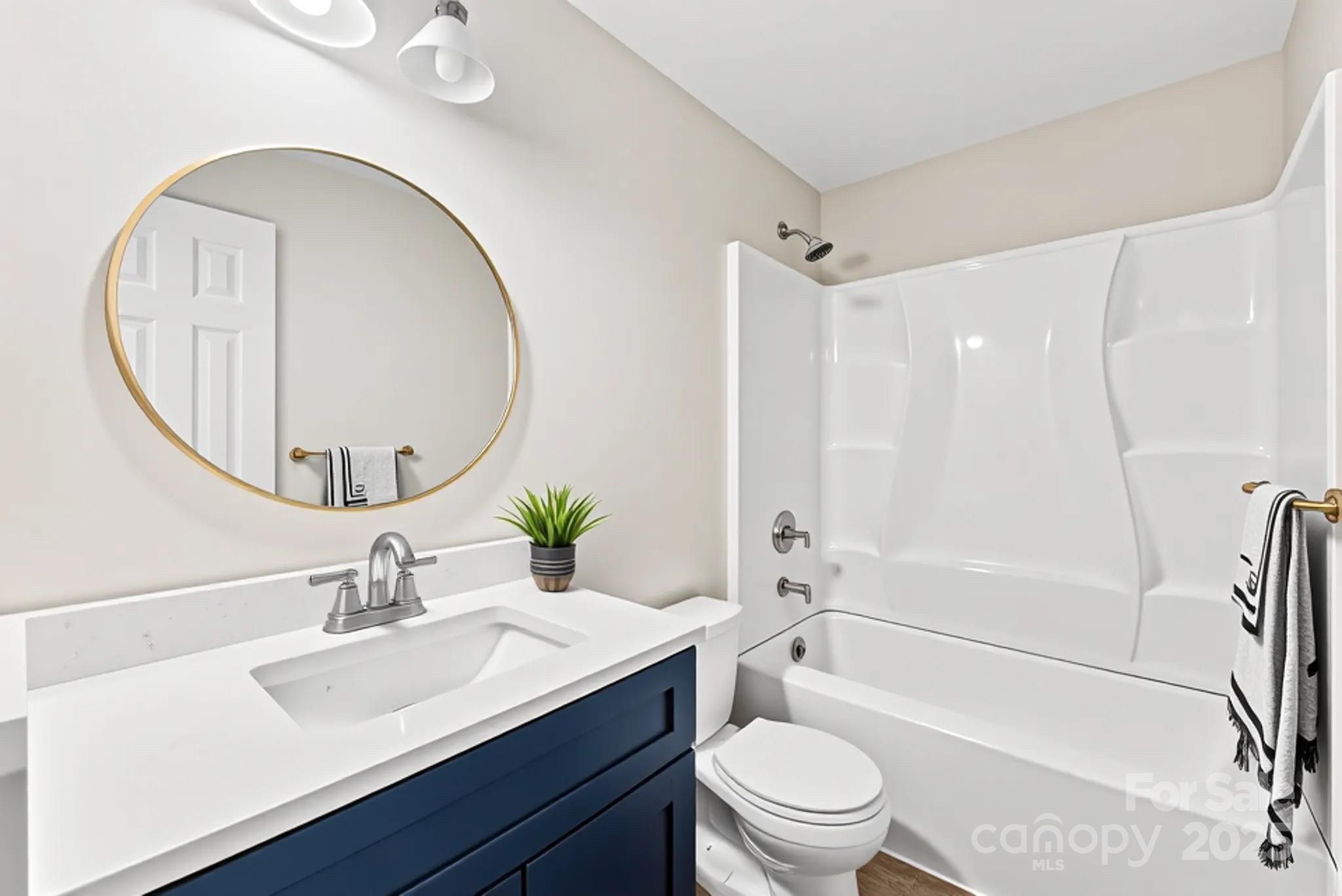 601 Rhyne Circle, Unit B Gastonia, NC 28054 - Photo 20 of 32 a bathroom with a sink a toilet and a mirror