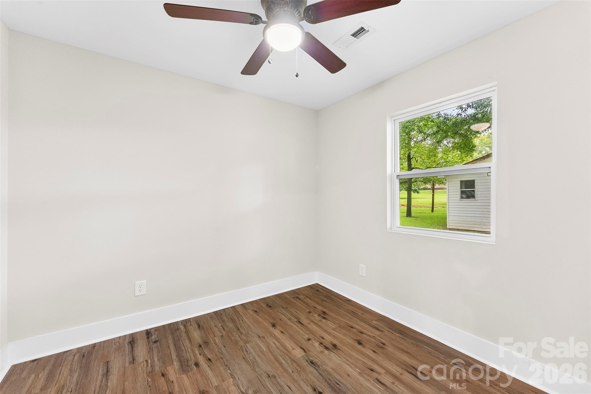 601 Rhyne Circle, Unit B Gastonia, NC 28054 - Photo 22 of 32 an empty room with a window and a ceiling fan