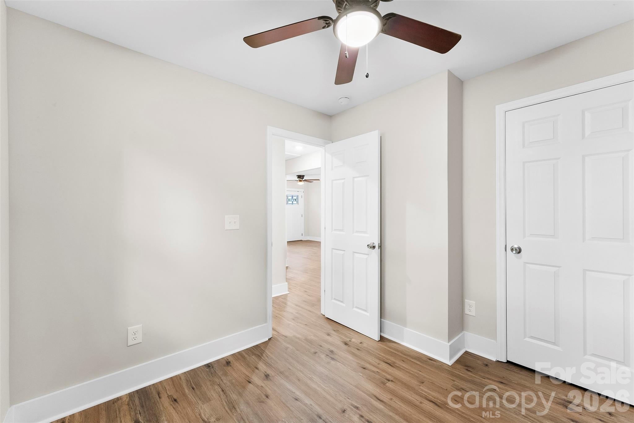 601 Rhyne Circle, Unit B Gastonia, NC 28054 - Photo 23 of 32 an empty room with wooden floor fan and windows
