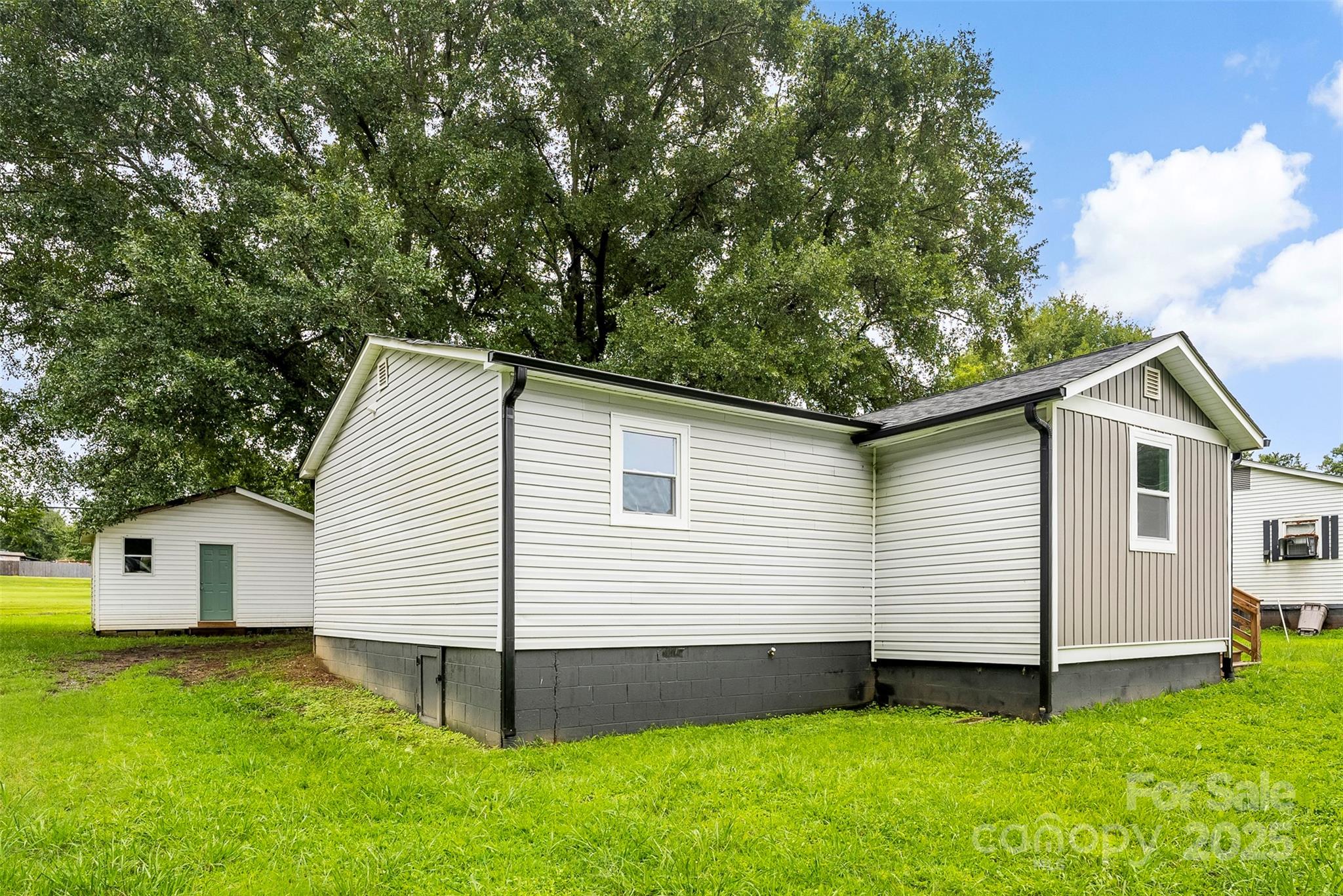 601 Rhyne Circle, Unit B Gastonia, NC 28054 - Photo 29 of 32 a view of a white house in front of a yard with large tree