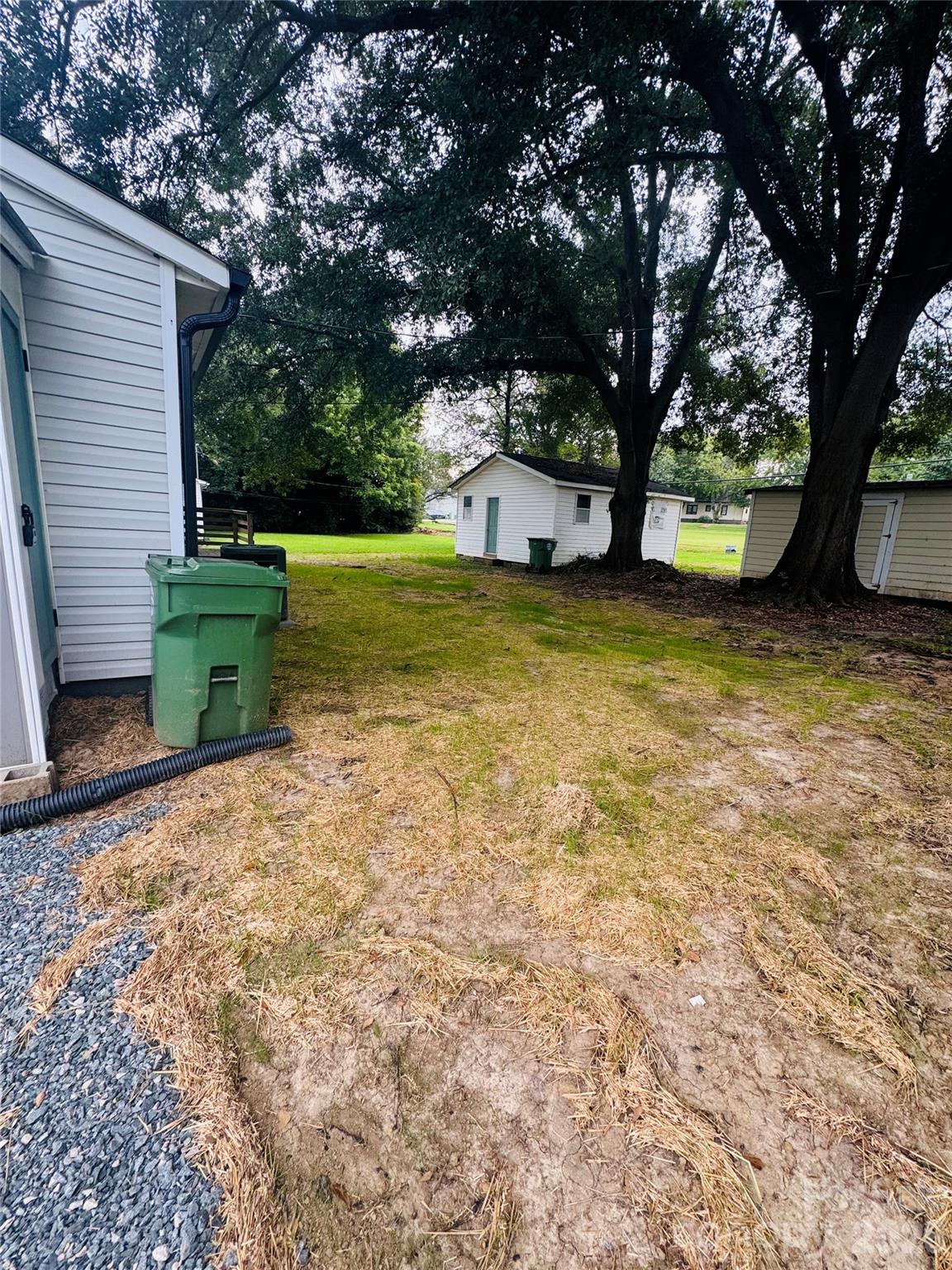 601 Rhyne Circle, Unit B Gastonia, NC 28054 - Photo 32 of 32 a view of a backyard with large tree and a small yard