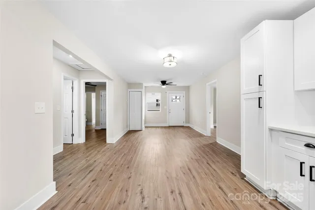 a view of a hallway with wooden floor