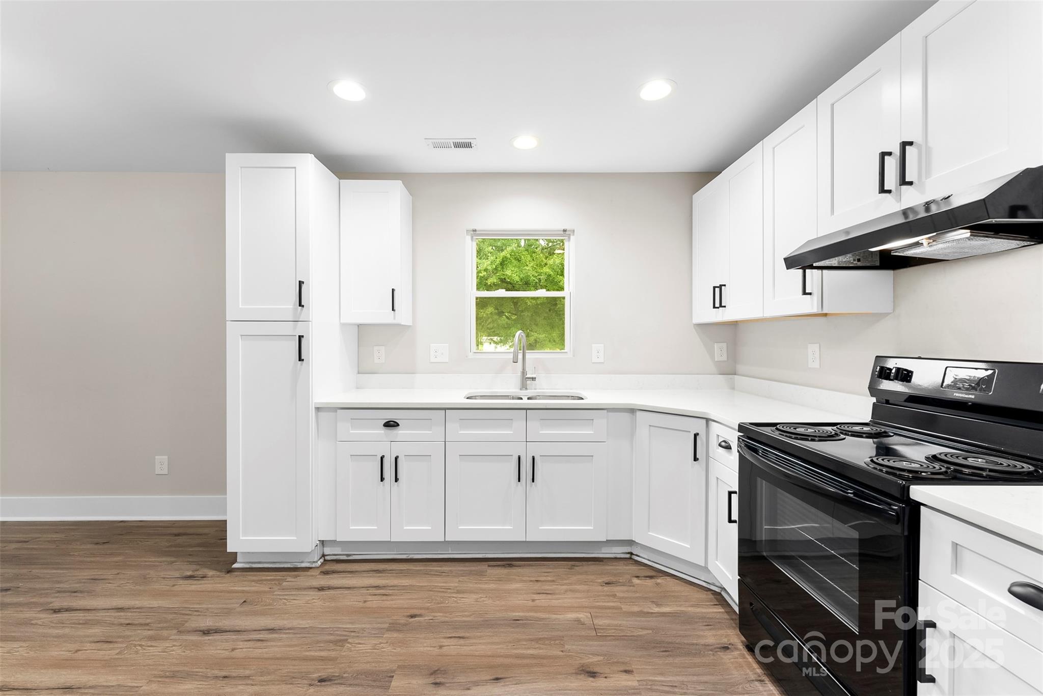601 Rhyne Circle, Unit B Gastonia, NC 28054 - Photo 10 of 32 a kitchen with granite countertop a sink stainless steel appliances and cabinets