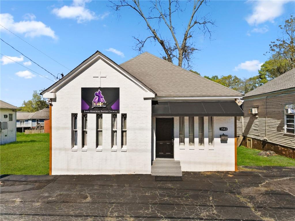 a view of a white house with a yard