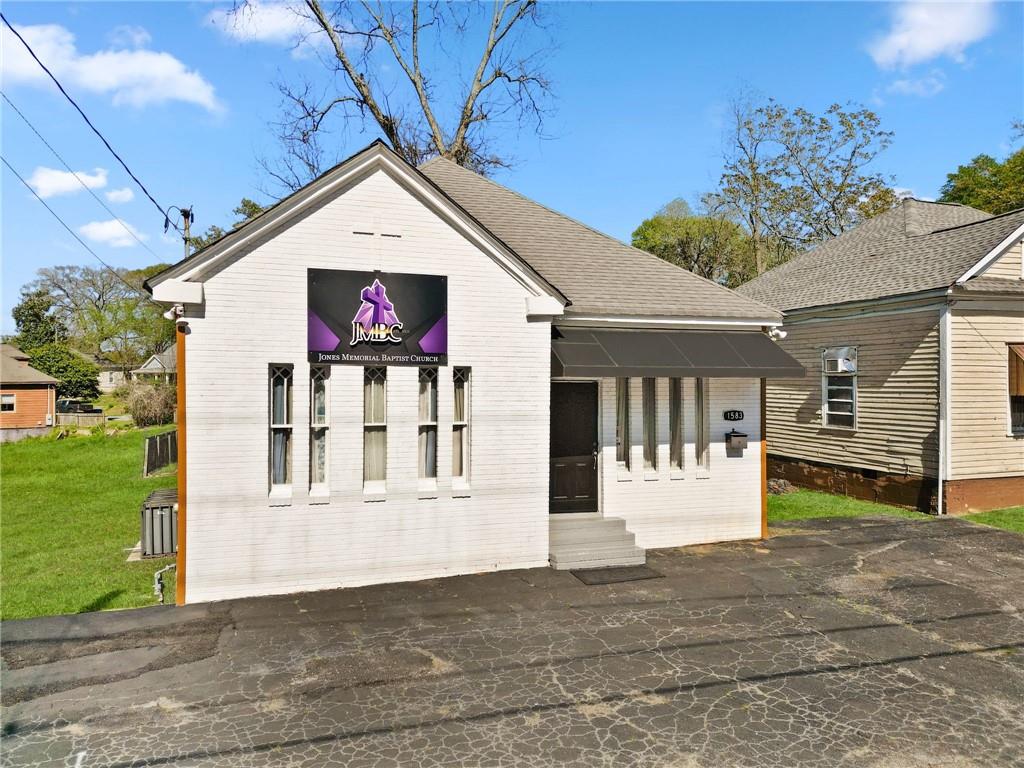 1583 Ralph David Abernathy Boulevard Southwest Atlanta, GA 30310 - Photo 2 of 24 a view of a house with a small yard and a large tree