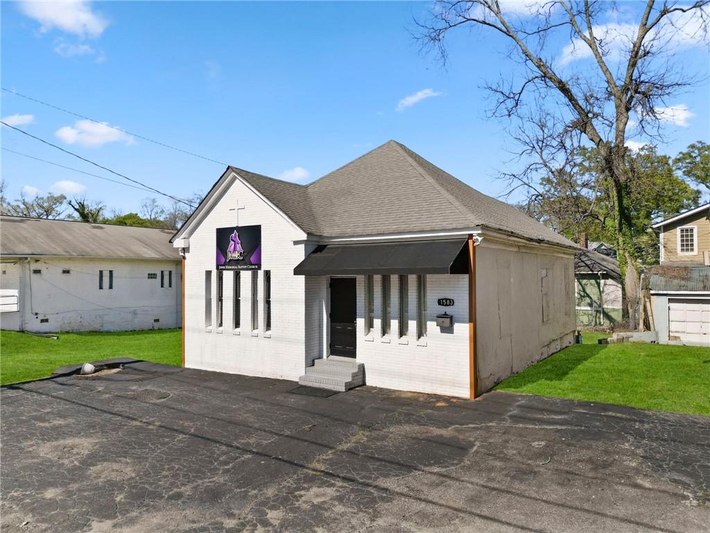1583 Ralph David Abernathy Boulevard Southwest Atlanta, GA 30310 - Photo 3 of 24 a front view of a house with a yard and garage