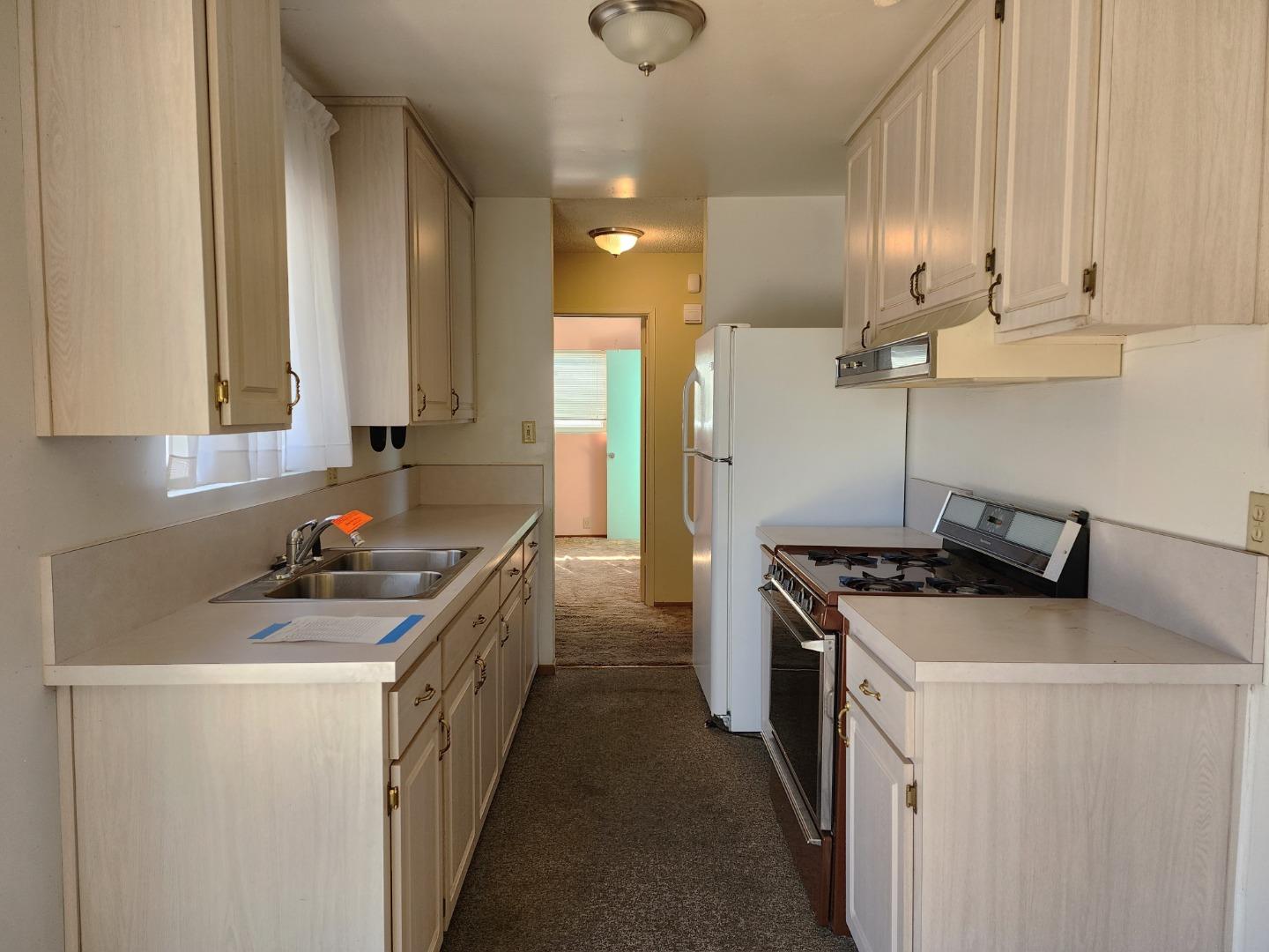 310 Dexter Drive Salinas, CA 93906 - Photo 6 of 22 a kitchen with stainless steel appliances a stove a sink and white cabinets