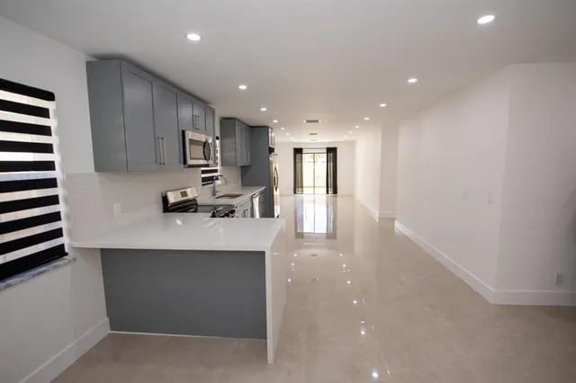 a view of empty room with windows and ceiling fan