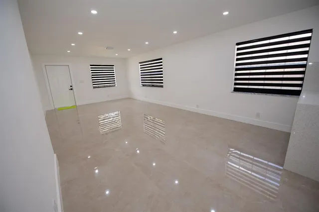 a kitchen with granite countertop a sink stainless steel appliances and cabinets
