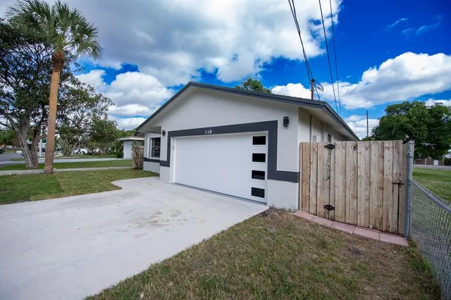 a view of a backyard with a fence