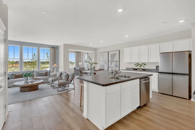 a kitchen with a sink stove and wooden cabinets