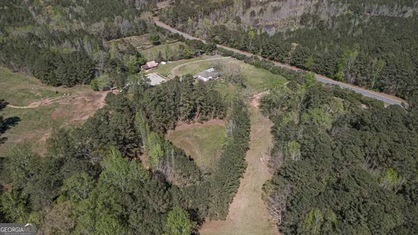 an aerial view of a house with yard swimming pool and outdoor seating