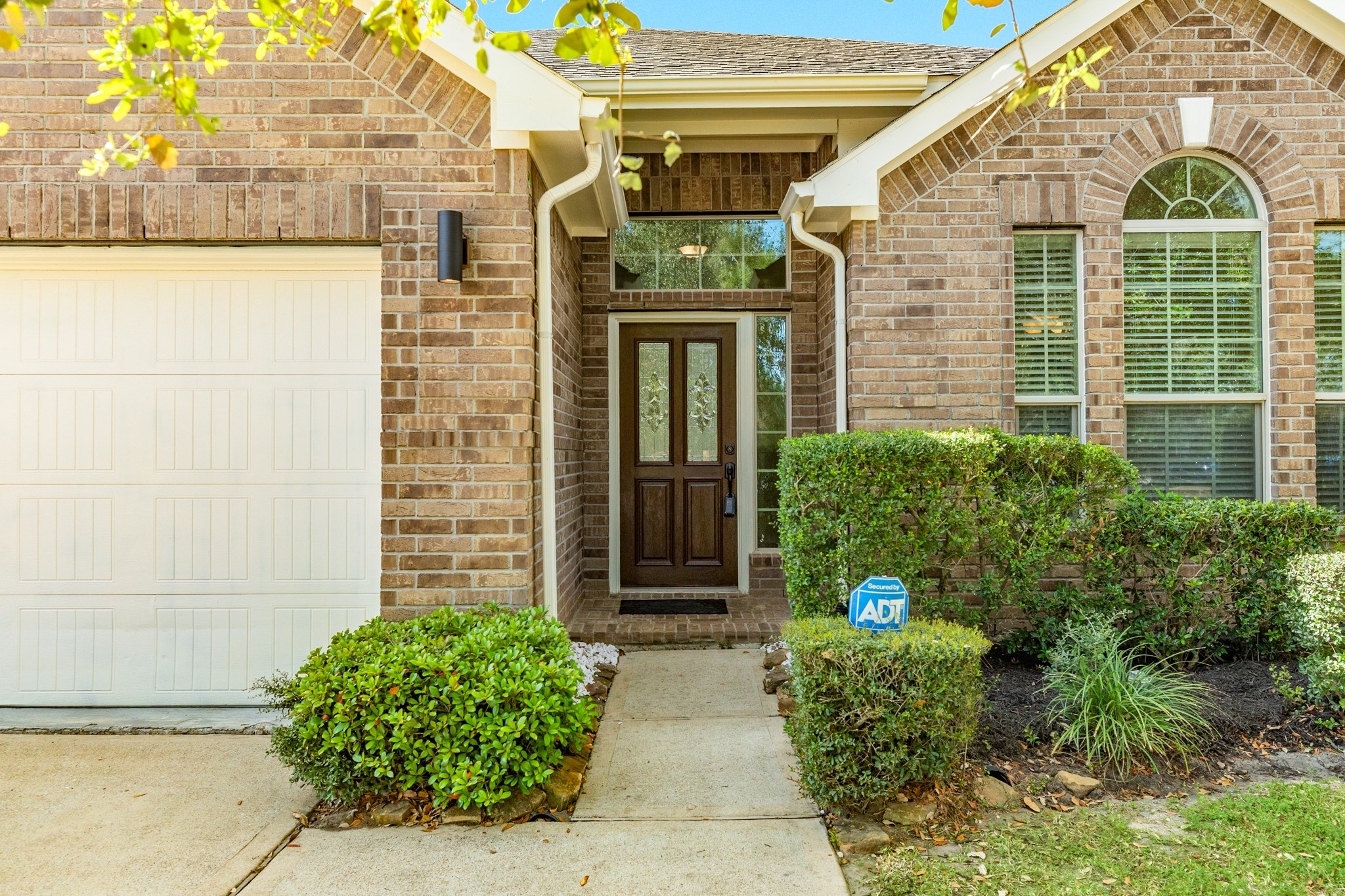 13417 Star Creek Lane Rosharon, TX 77583 - Photo 2 of 41 Upon entering, you are greeted by this beautiful wooden and glass front door, which adds just the perfect touch to this beautiful home. The combination of wood and glass creates an inviting entrance, enhancing the overall charm and elegance of the property.