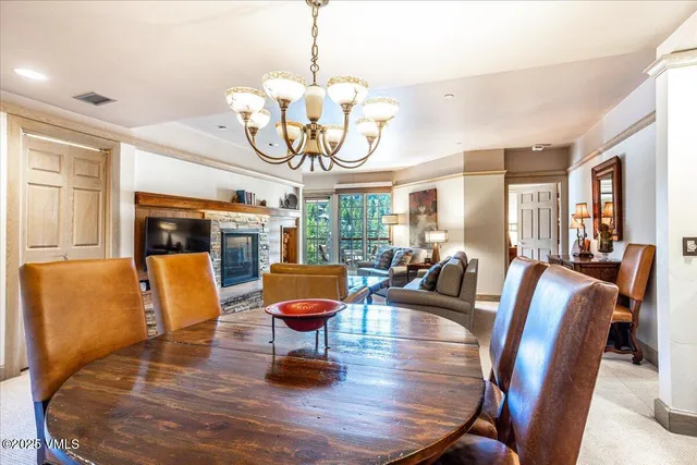a living room with fireplace furniture and a chandelier