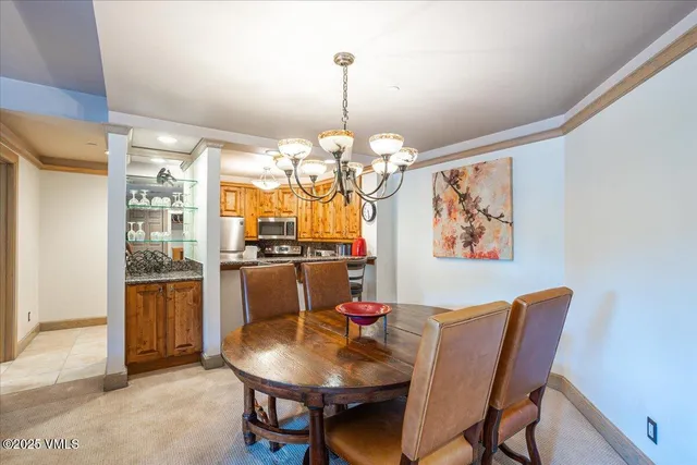 a dining room with furniture a livingroom and chandelier