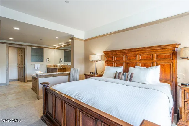 a bedroom with a bed and a kitchen view