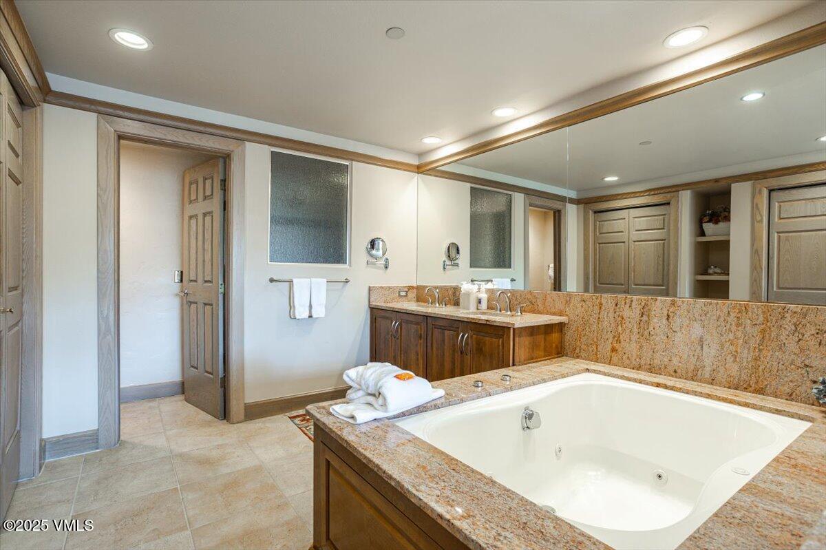 46 Avondale Lane, Unit R312 Beaver Creek, CO 81620 - Photo 23 of 47 a bathroom with a tub sink and mirror