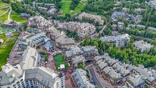 a front view of a house with a yard and potted plants