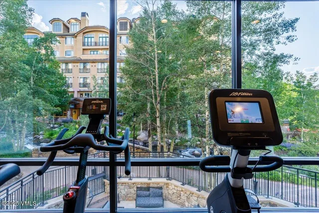 a room with gym equipment and a large window
