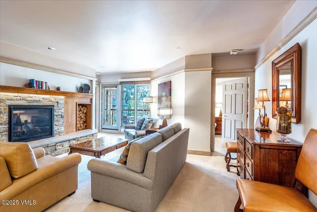 a living room with furniture and a fireplace