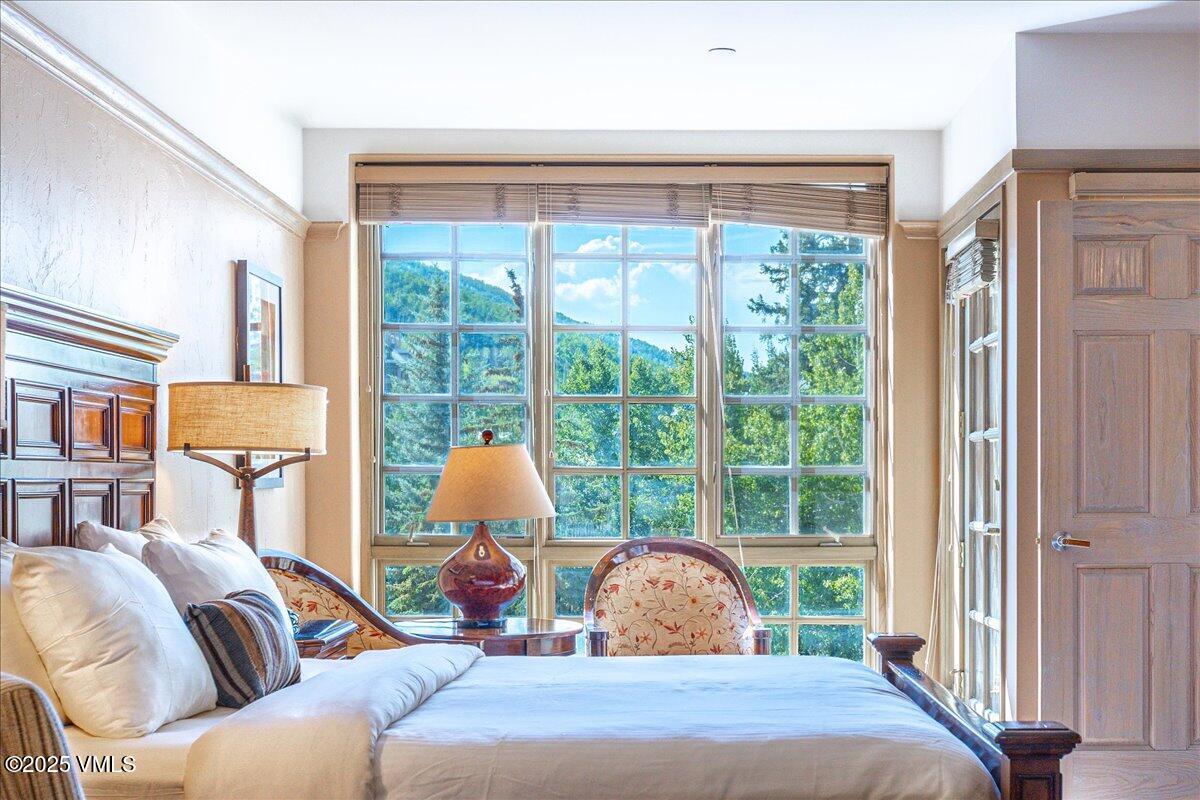 46 Avondale Lane, Unit R312 Beaver Creek, CO 81620 - Photo 8 of 47 a bedroom with a bed and a large window with outer view