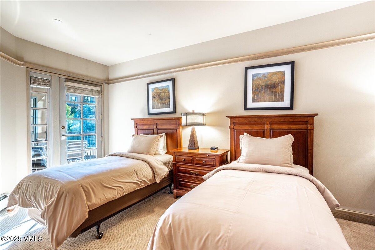 46 Avondale Lane, Unit R312 Beaver Creek, CO 81620 - Photo 9 of 47 a bedroom with two beds and a night stand