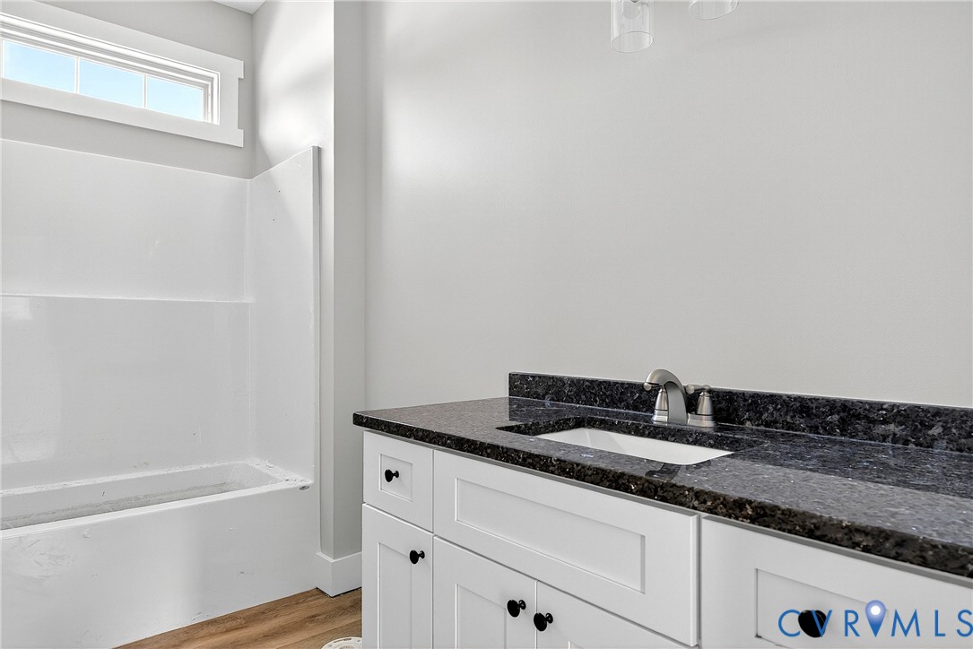 2732 Venter Road Aylett, VA 23009 - Photo 11 of 32 a bathroom with a granite countertop sink and a bathtub