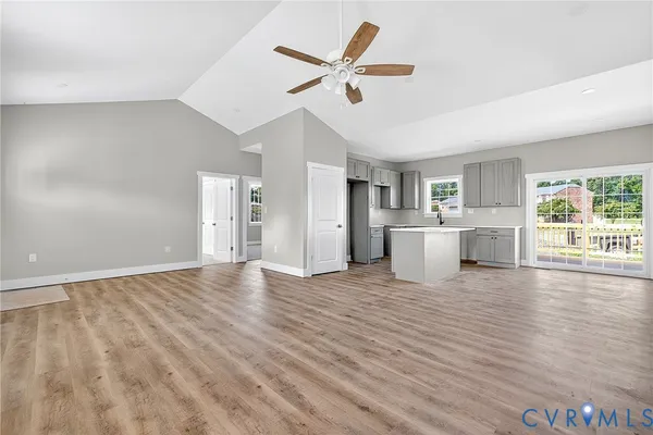 a view of a livingroom with wooden floor and a ceiling fan