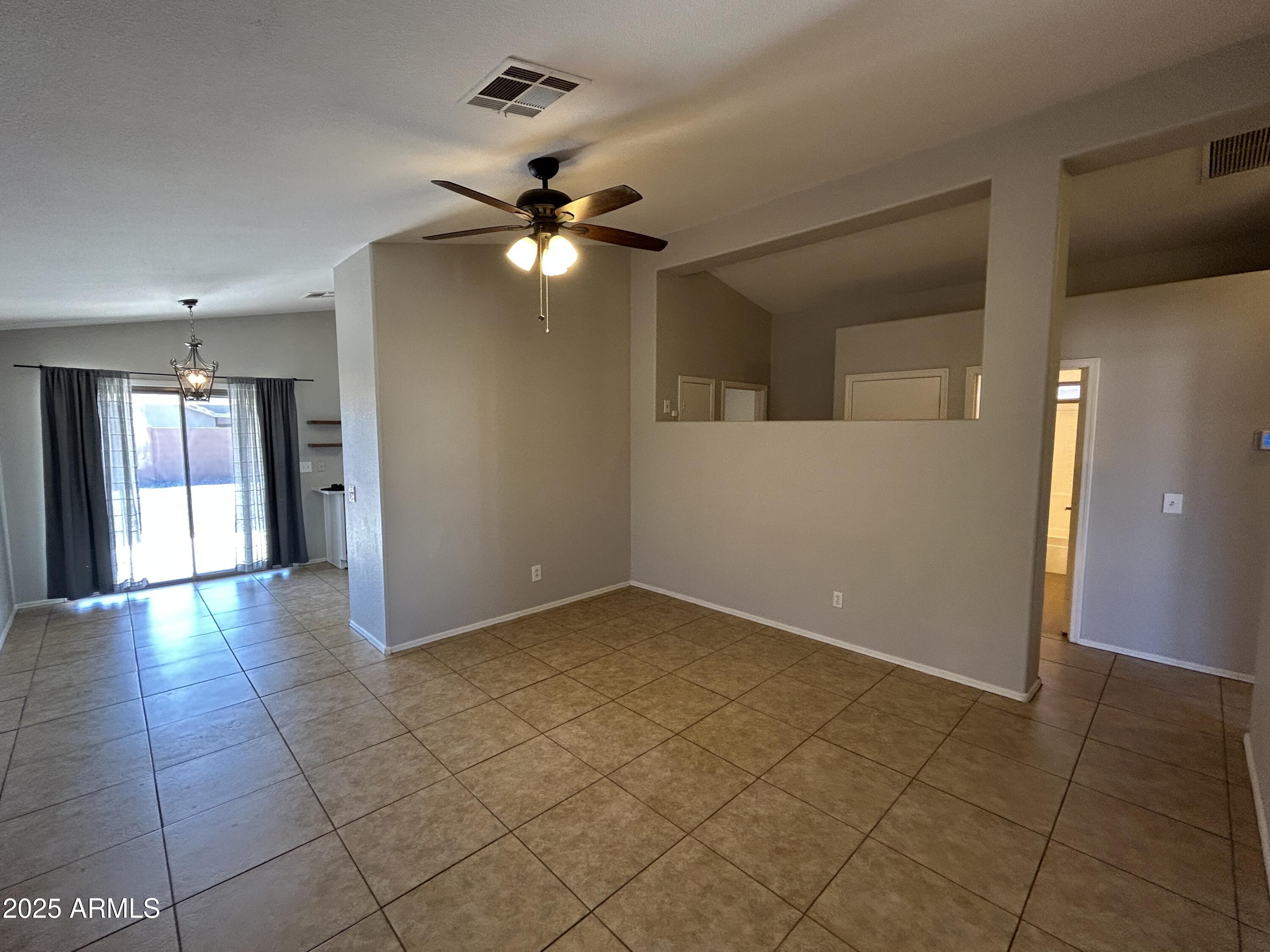 15011 West Redfield Road Surprise, AZ 85379 - Photo 3 of 16 a view of an empty room with window and chandelier fan