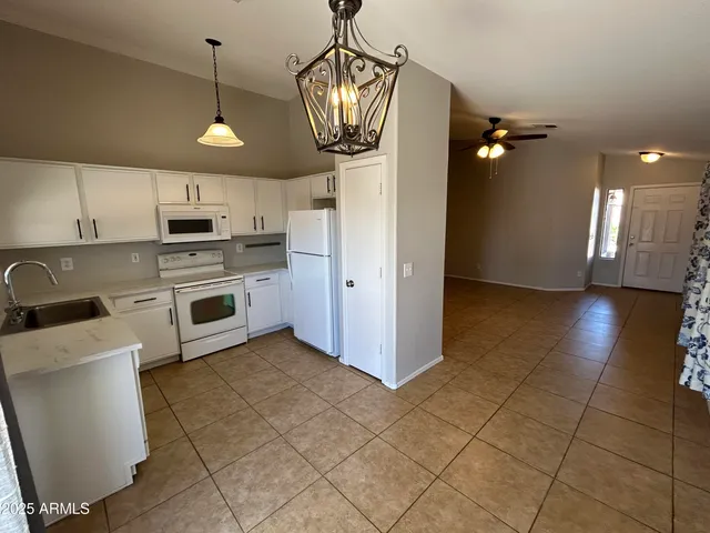 a view of a kitchen with a sink and cabinets