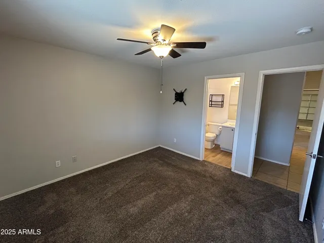 an empty room with closet and wooden floor