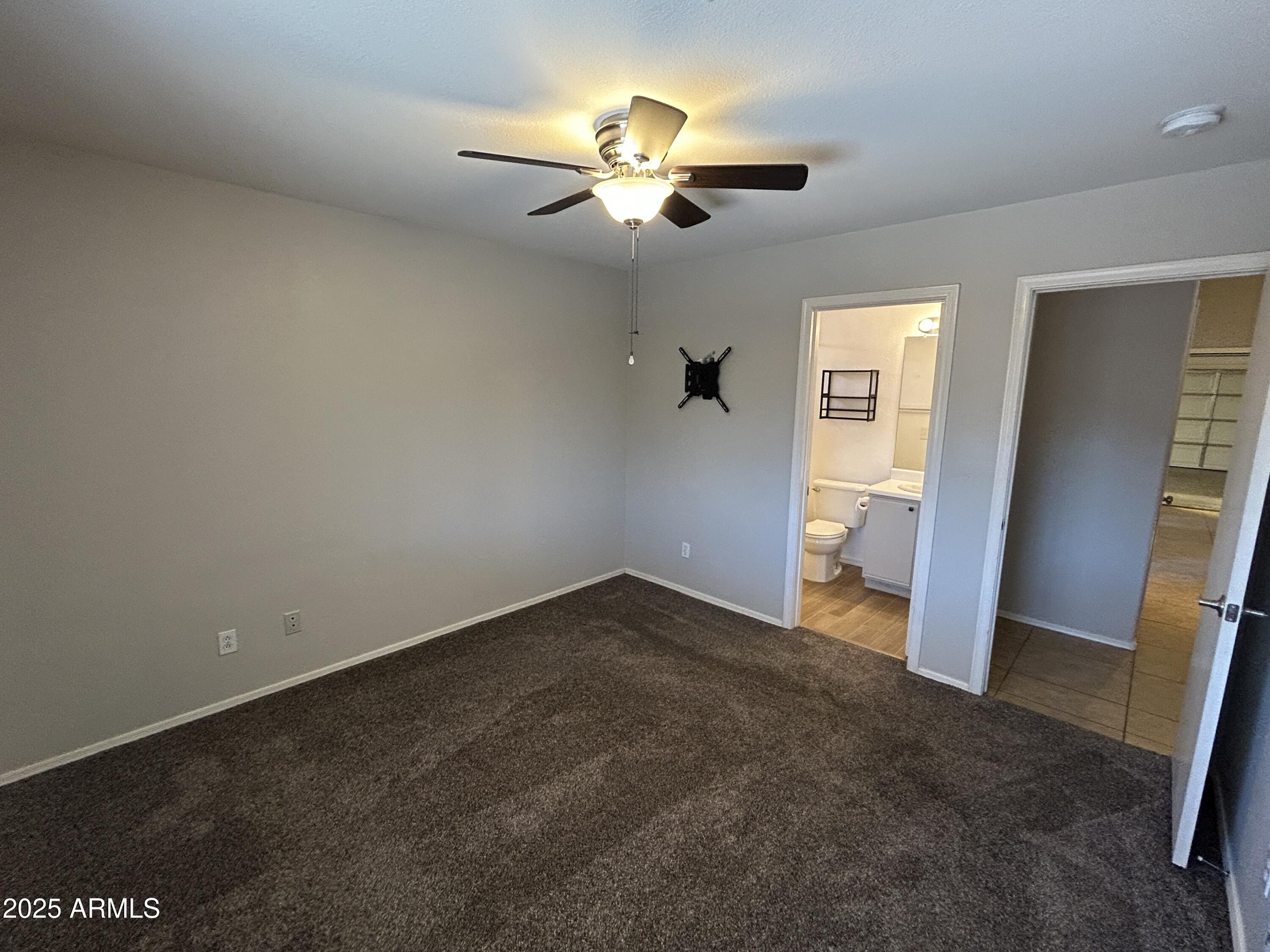 15011 West Redfield Road Surprise, AZ 85379 - Photo 8 of 16 an empty room with closet and wooden floor