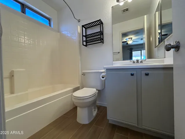 a bathroom with a toilet a sink and bathtub