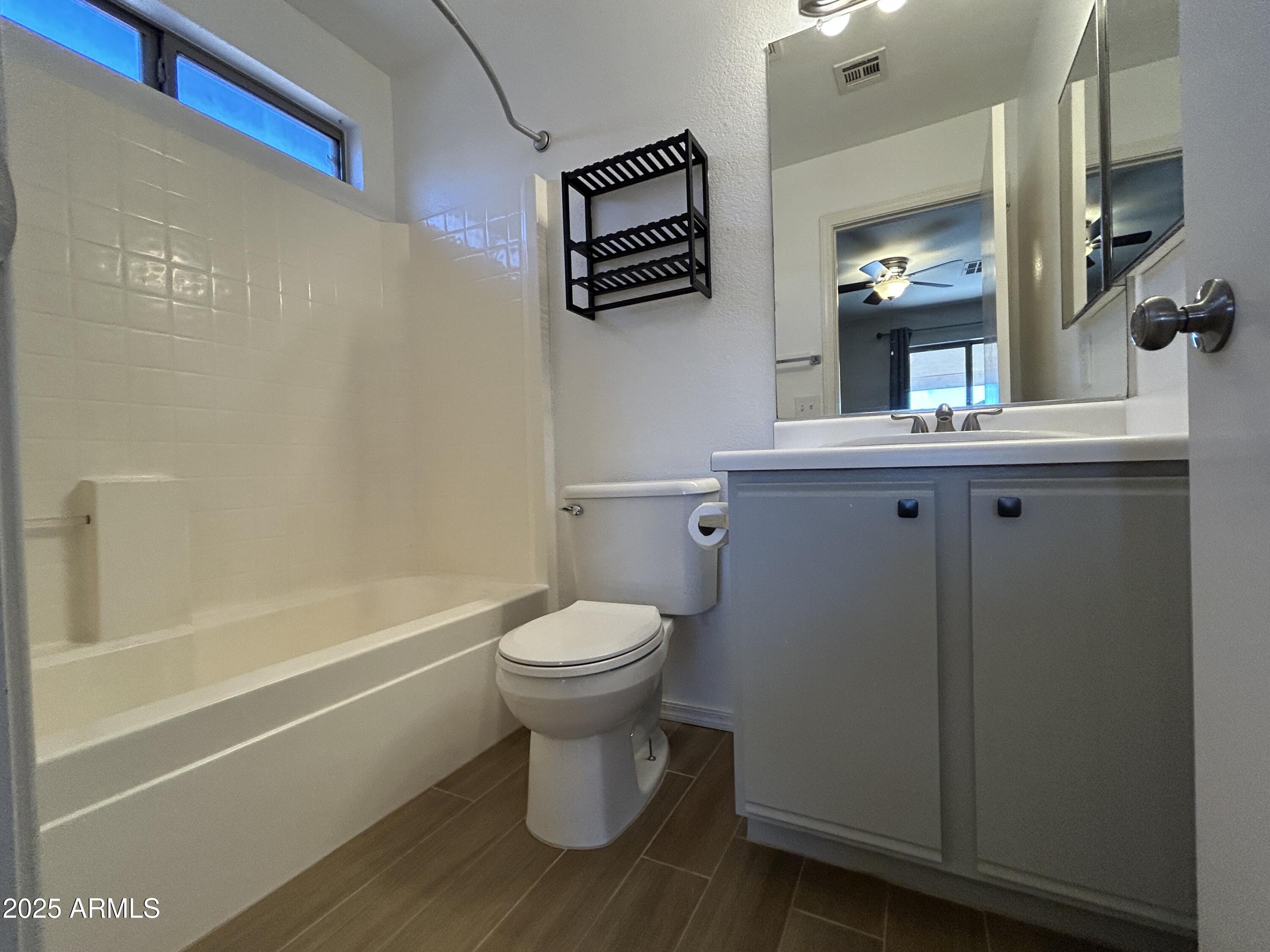 15011 West Redfield Road Surprise, AZ 85379 - Photo 9 of 16 a bathroom with a toilet a sink and bathtub