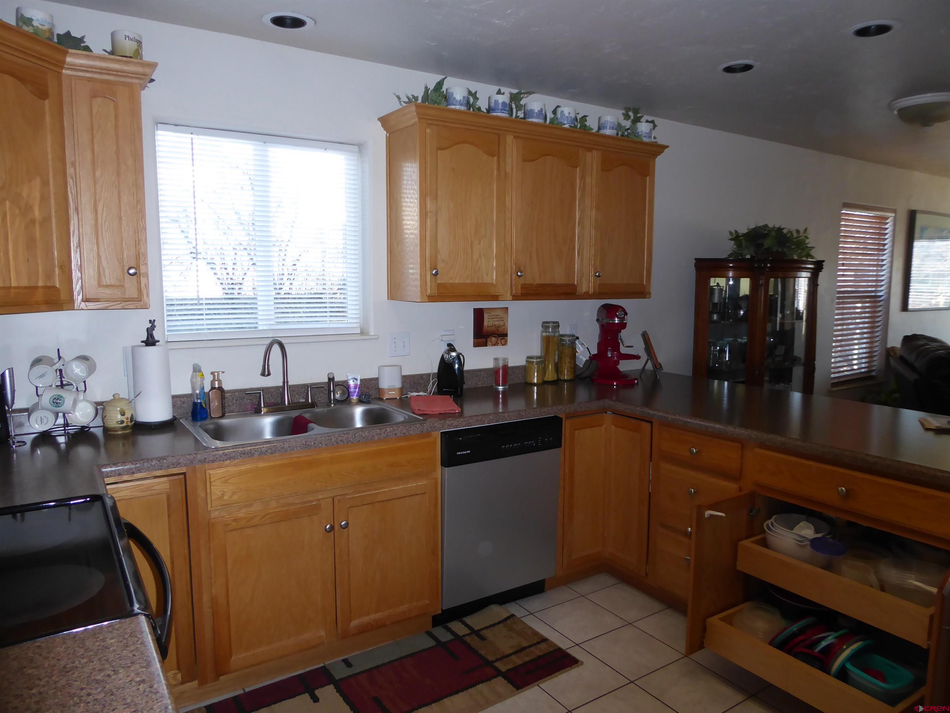 800 Northeast 2nd Street Cedaredge, CO 81413 - Photo 13 of 45 a kitchen with a sink stove top oven and cabinets