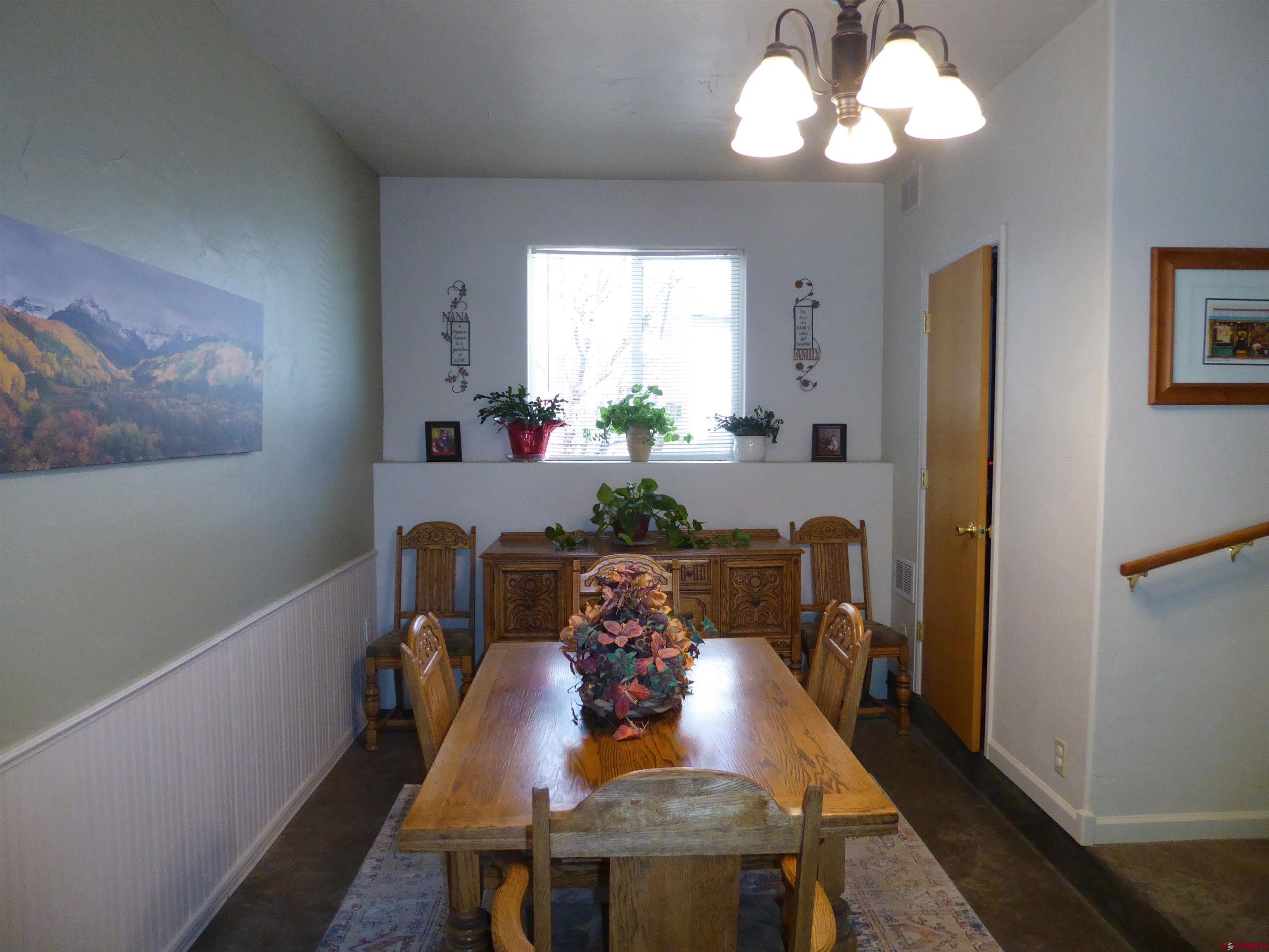 800 Northeast 2nd Street Cedaredge, CO 81413 - Photo 14 of 45 a view of a dining room with furniture a chandelier and wooden floor