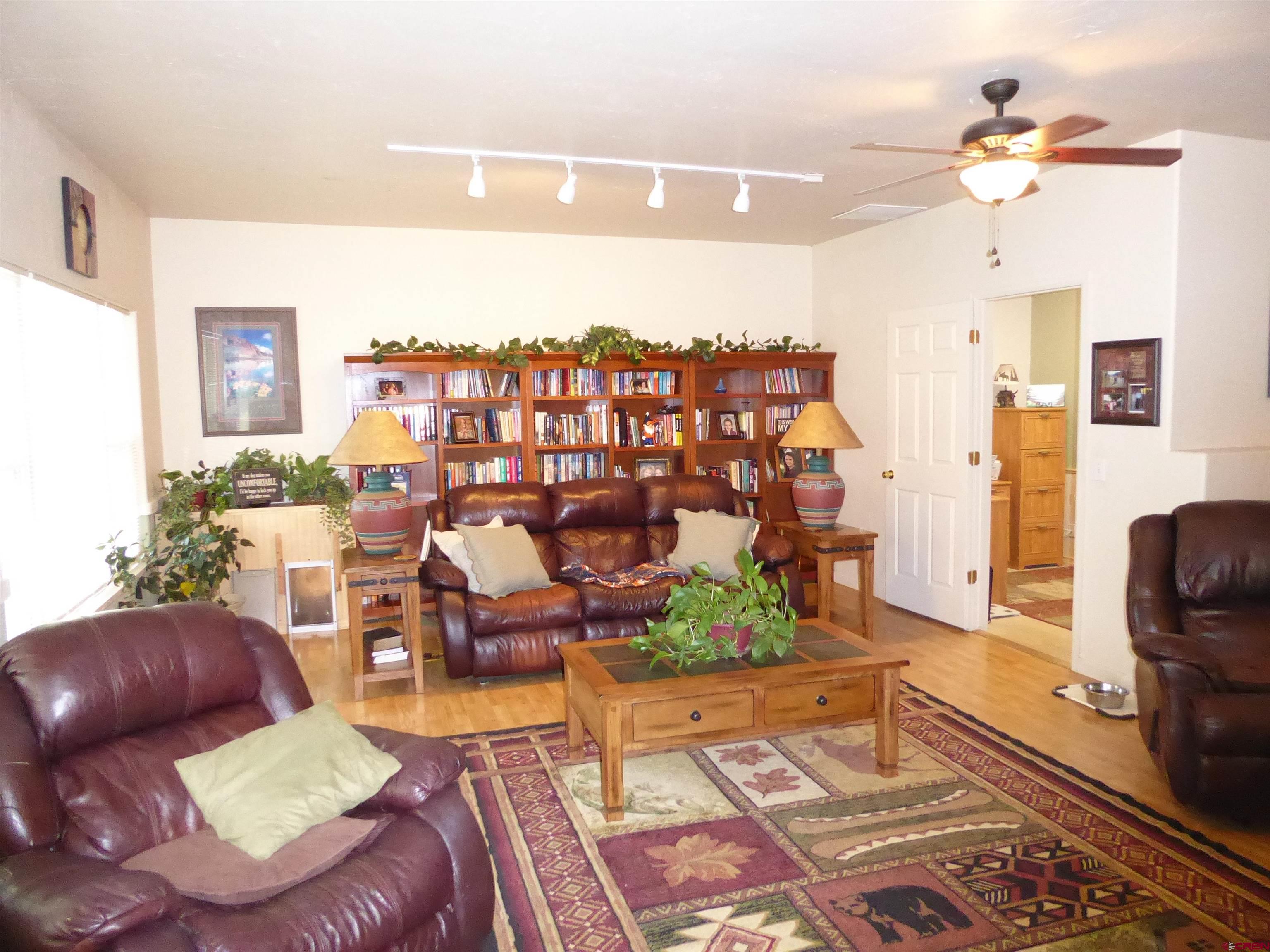 800 Northeast 2nd Street Cedaredge, CO 81413 - Photo 15 of 45 a living room with furniture and a floor to ceiling window