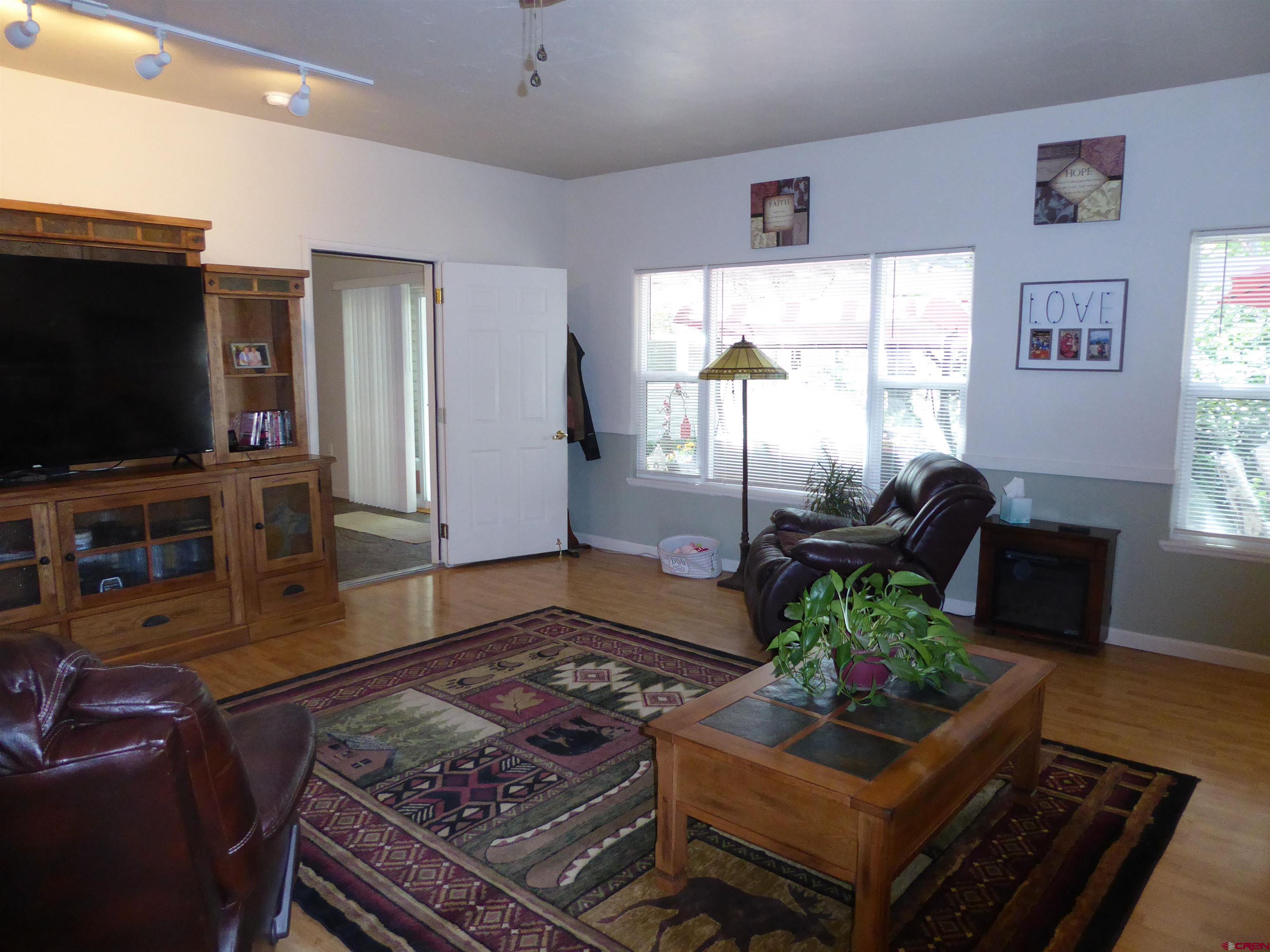 800 Northeast 2nd Street Cedaredge, CO 81413 - Photo 19 of 45 a living room with furniture and a flat screen tv