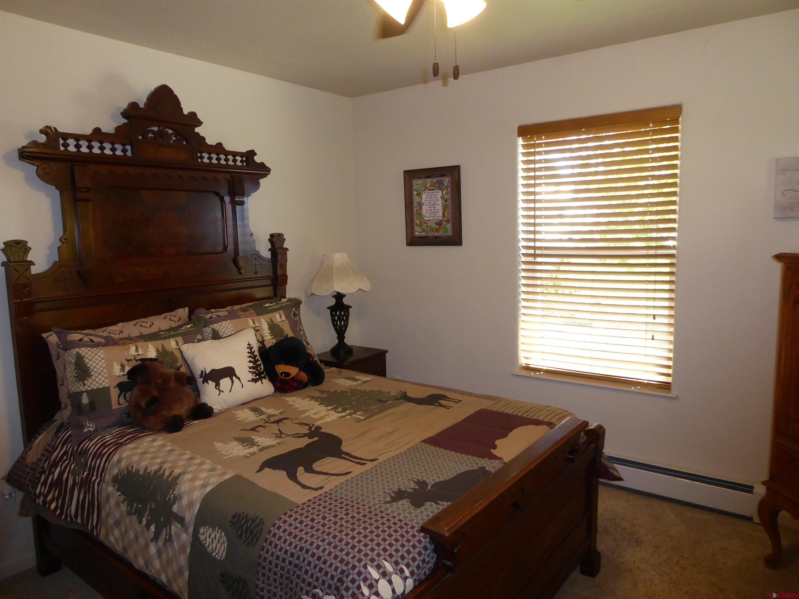 800 Northeast 2nd Street Cedaredge, CO 81413 - Photo 23 of 45 a bedroom with a bed and a window