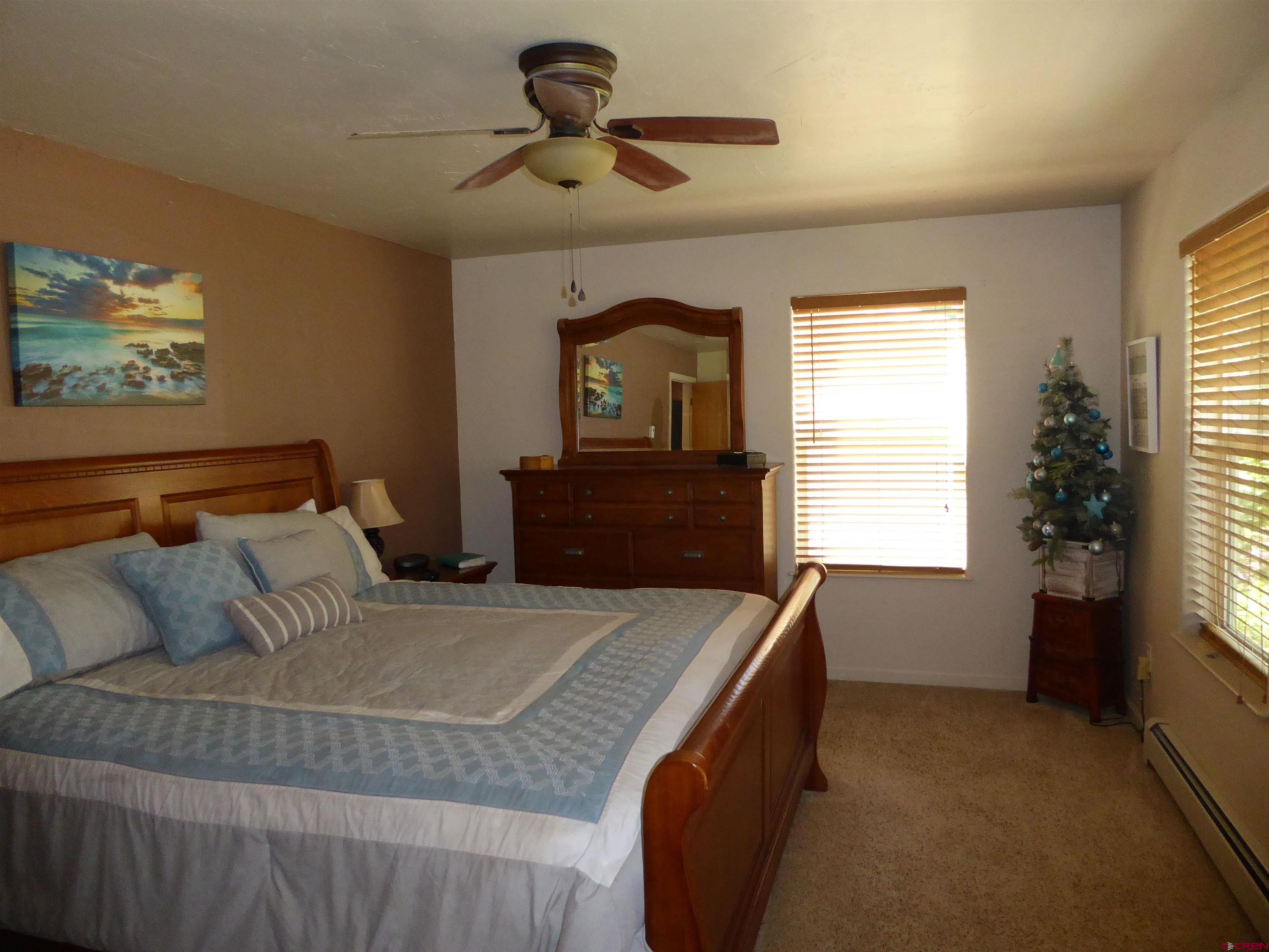 800 Northeast 2nd Street Cedaredge, CO 81413 - Photo 25 of 45 a bedroom with a bed and a window
