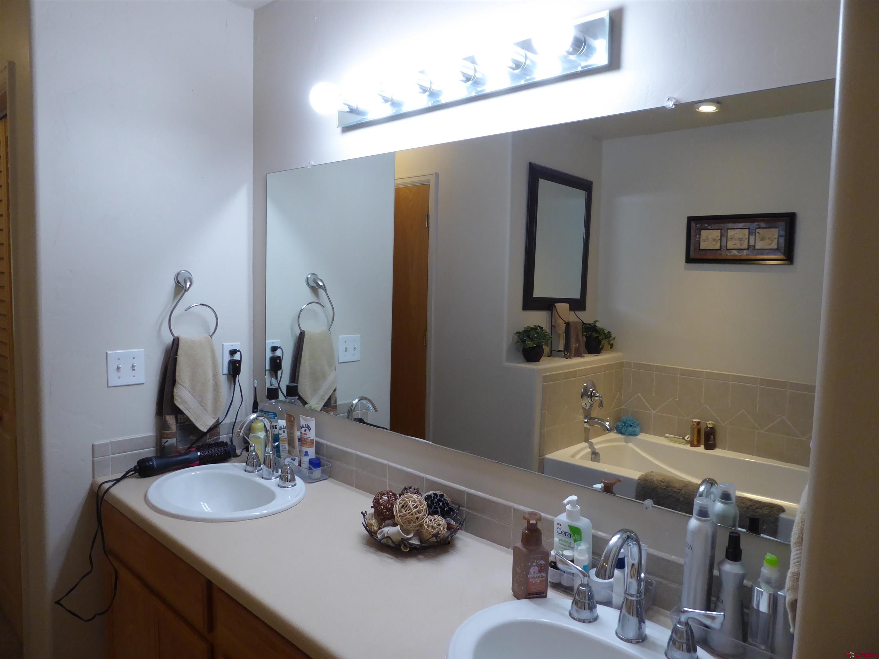 800 Northeast 2nd Street Cedaredge, CO 81413 - Photo 29 of 45 a bathroom with a sink vanity and mirror