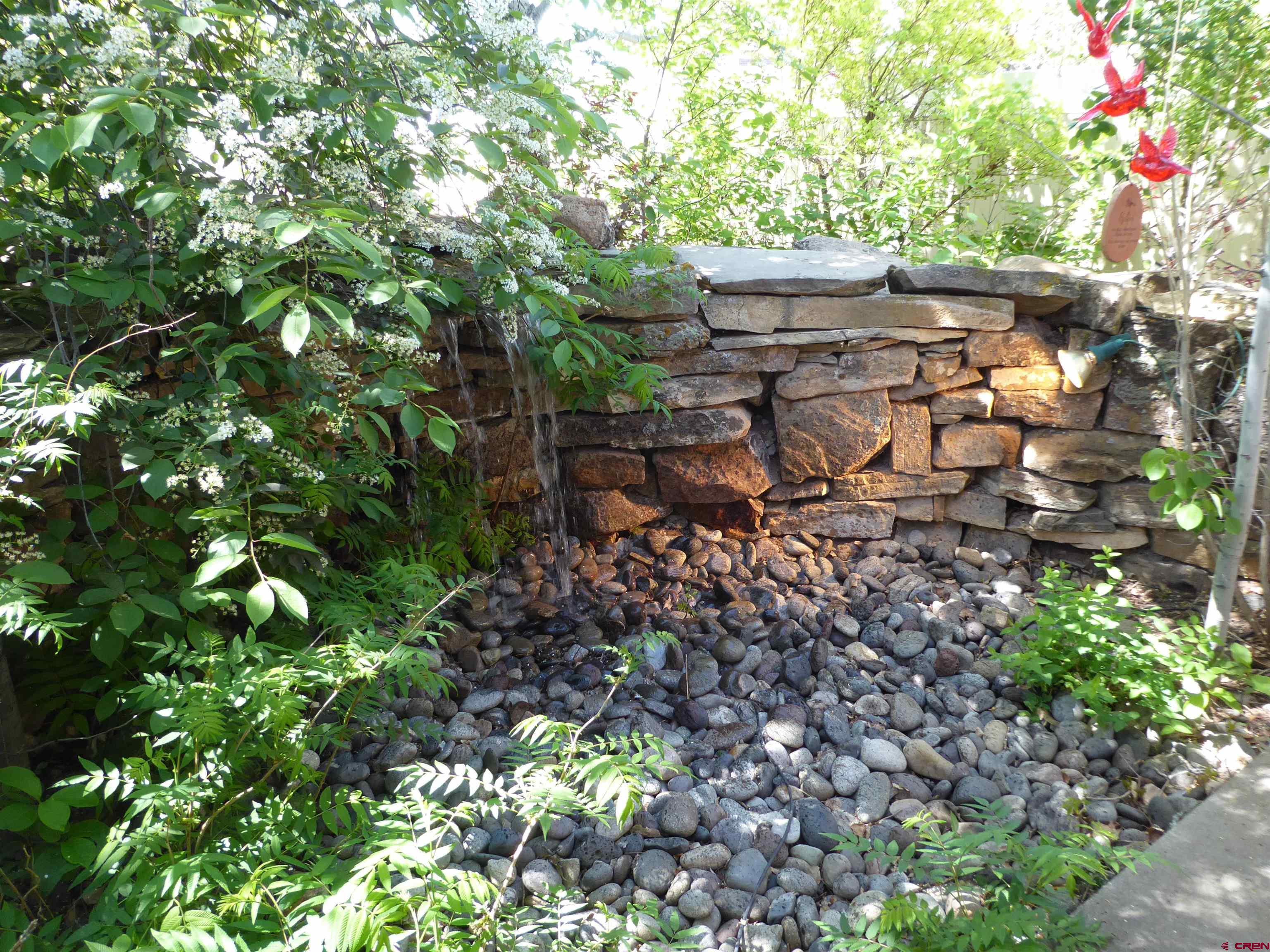 800 Northeast 2nd Street Cedaredge, CO 81413 - Photo 34 of 45 a backyard of a house with lots of green space and a fountain