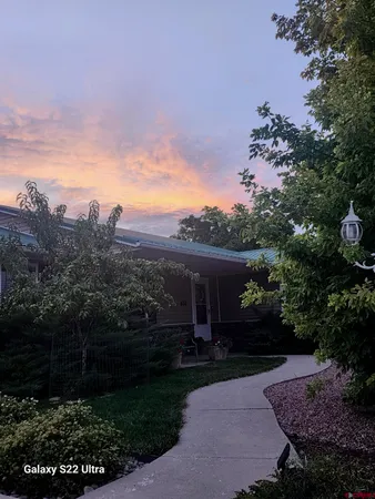 a view of house with outdoor space and garden