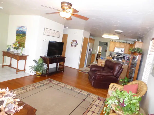 a view of a dining room with furniture a chandelier and wooden floor