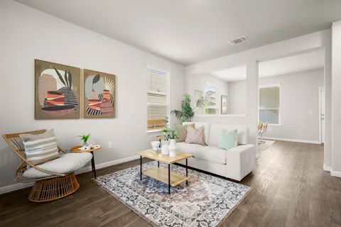 a living room with furniture and wooden floor