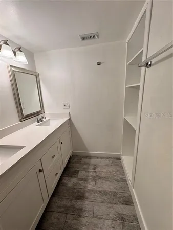 a bathroom with a double vanity sink and a mirror
