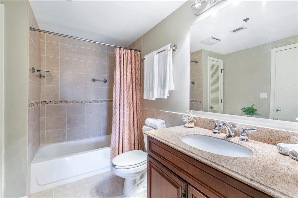 1280 West Peachtree Street Northwest, Unit 3806 Atlanta, GA 30309 - Photo 11 of 35 a bathroom with a granite countertop sink toilet and shower