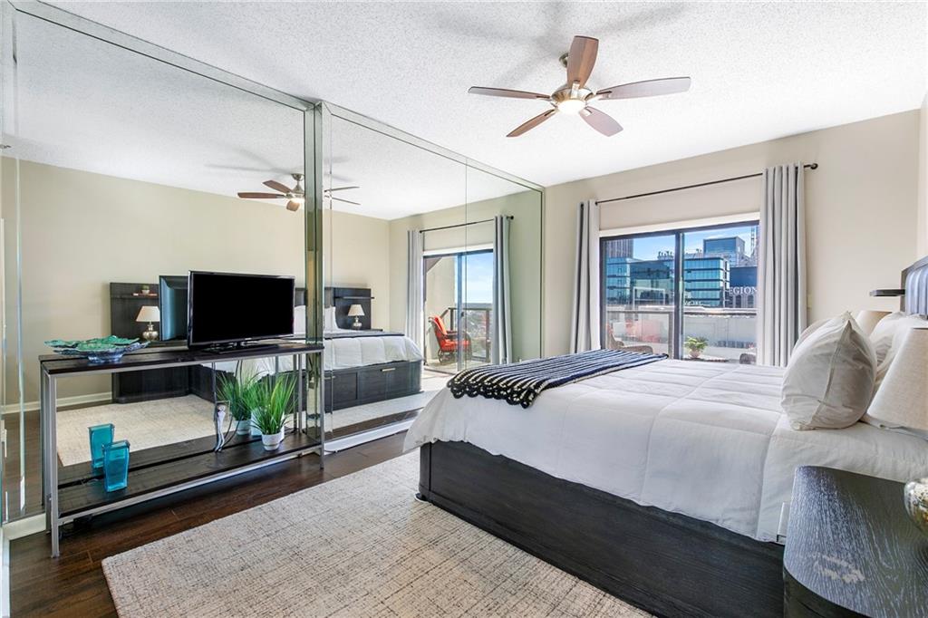 1280 West Peachtree Street Northwest, Unit 3806 Atlanta, GA 30309 - Photo 14 of 35 a bedroom with a bed a couch and a flat screen tv